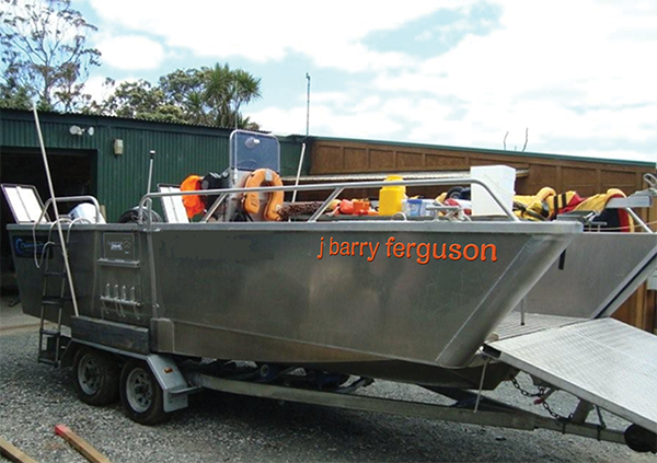 The surplus-to-operations landing barge bearing a first design attempt at its pending new name, the J Barry Ferguson.