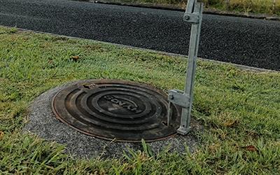 Cimino-conceived manhole cover lifter