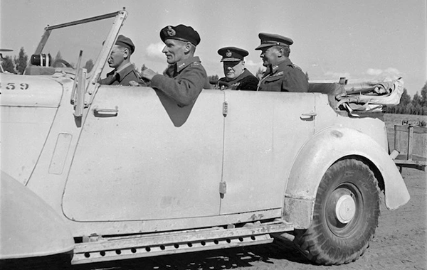 Winston Churchill inspecting units of the New Zealand Division with, clockwise, Bernard Freyberg, Bernard Montgomery; John Poston, driver