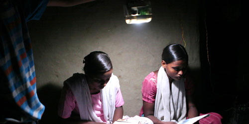 Girls reading by D Light lantern