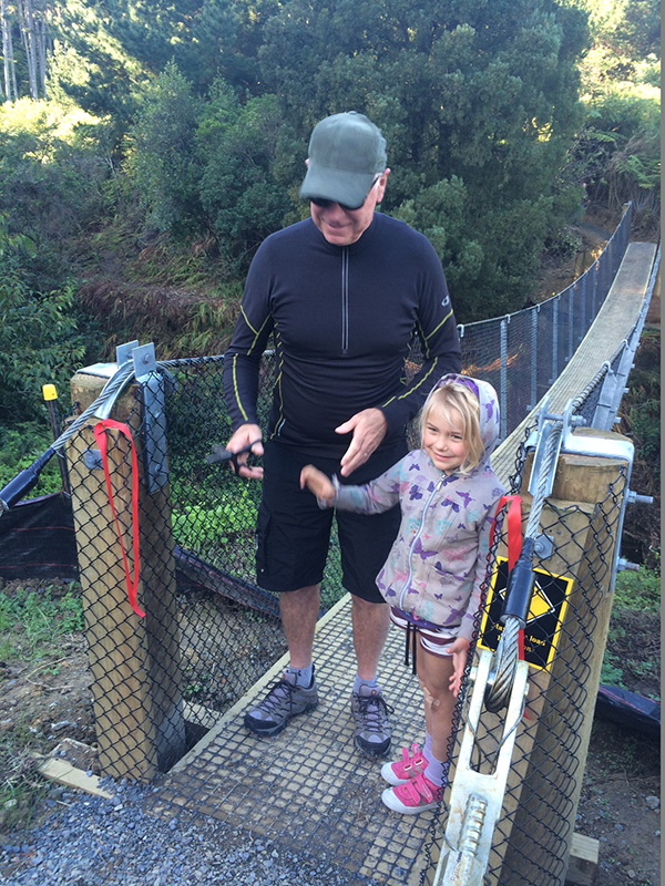 Sir Stephen Tindall cutting ribbon for new footbridge