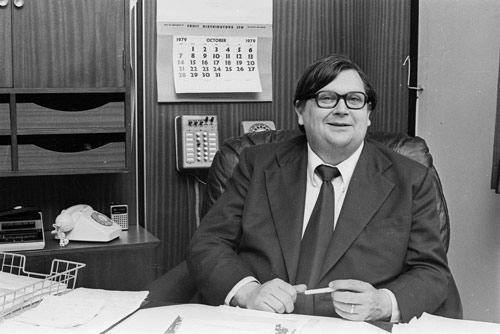 David Lange, seated at desk