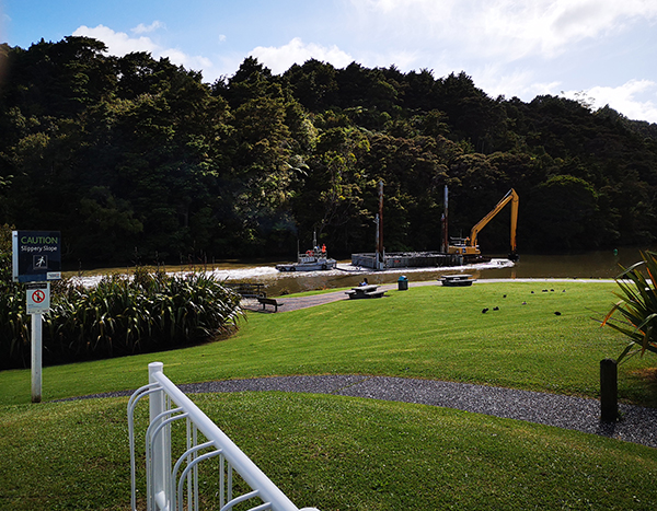 Dredging barge passes Old Masonic Hall